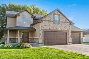 View of front of house featuring roof with shingles, driveway, and a garage