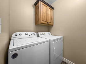 Laundry area with washer and dryer and cabinet space