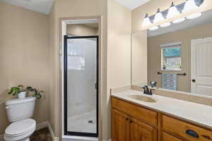 Full bath featuring a shower stall and vanity