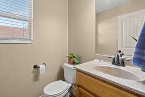 Half bath featuring vanity and toilet