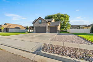 View of front of house with driveway, brick siding, roof with shingles, an attached garage, and a residential view