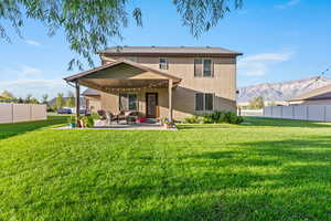 Back of property featuring a mountain view, a patio, and stucco siding
