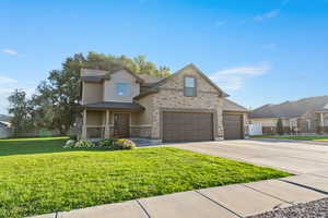 View of front of home featuring concrete driveway, a garage, and covered porch