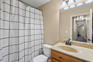 Bathroom featuring vanity and curtained shower