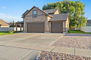 View of front facade featuring brick siding, concrete driveway, and an attached garage