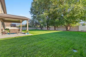 Fenced backyard with a patio area and an outdoor hangout area