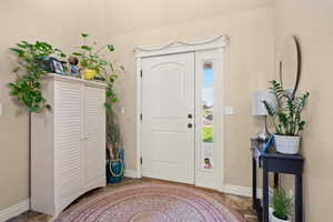 Foyer entrance with baseboards