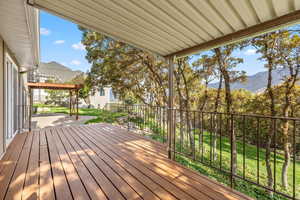 Wooden deck featuring a yard and a mountain view