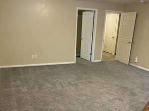 Mother-in-law Spare room with a textured ceiling and carpet floors