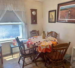 Dining room with wood-type flooring and baseboards