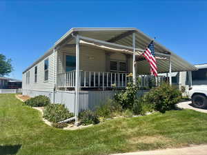 View of front of home featuring a front lawn and a porch
