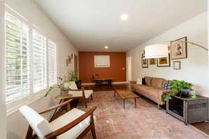 Living area featuring healthy amount of natural light, wood finished floors, and recessed lighting