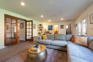 Living area featuring french doors, carpet flooring, recessed lighting, and attic access