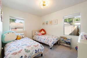 Carpeted bedroom with a textured ceiling