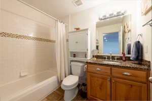 Full bath with shower / bath combo with shower curtain and vanity