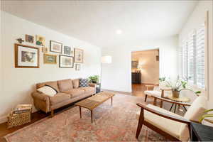 Living room featuring wood finished floors, recessed lighting, and a textured ceiling