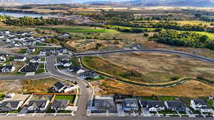 Aerial view of property and surrounding area with nearby suburban area and a water and mountain view