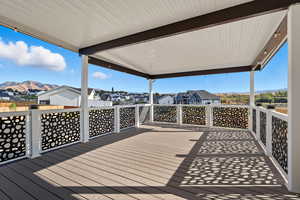 Deck with a residential view and a mountain view