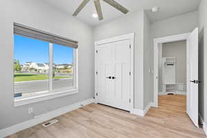 Unfurnished bedroom with light wood finished floors, a ceiling fan, a closet, and recessed lighting