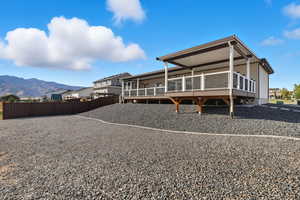 Back of house featuring a deck with mountain view
