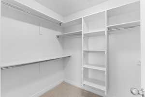 View of spacious closet in primary bedroom