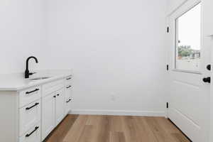 Washroom featuring light wood-style flooring and baseboards