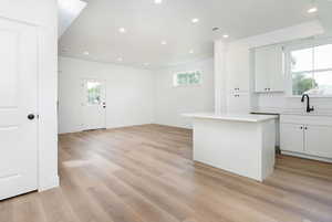 Kitchen with white cabinetry, plenty of natural light, recessed lighting, and a center island