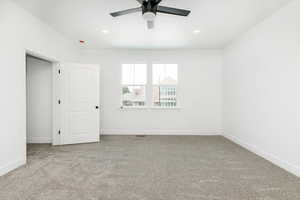 Unfurnished bedroom with light carpet, a ceiling fan, and recessed lighting