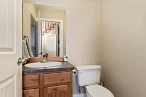 Half bathroom with vanity and toilet