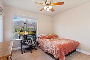 Bedroom featuring carpet floors, a mountain view, and ceiling fan