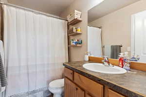 Full bath with vanity and curtained shower