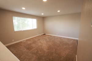 Spare room with carpet and recessed lighting
