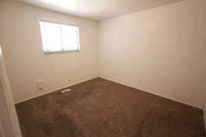 Spare room with carpet flooring and baseboards