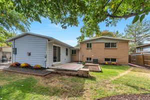Rear view of house with a wooden deck and brick siding
