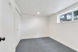 Unfurnished bedroom featuring carpet floors, a closet, and recessed lighting