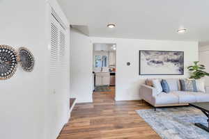 Living room featuring light wood-style flooring and recessed lighting