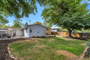 Rear view of house with a patio and a fenced backyard