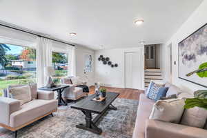 Living area with wood finished floors and stairway