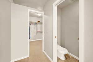 Bathroom with a bidet and baseboards