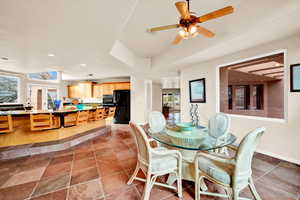 Dining area with ceiling fan, recessed lighting, and stone tile flooring