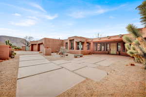 Adobe home featuring stucco siding, a mountain view, and driveway