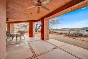 View of patio / terrace featuring ceiling fan, outdoor dining area, and a mountain view