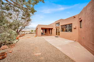 Back of house featuring stucco siding and a patio area