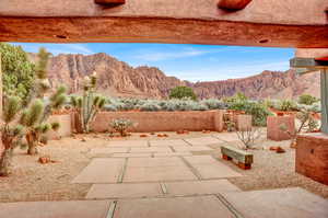 Fenced backyard featuring a patio area and a mountain view