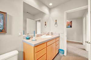 Half bathroom featuring vanity and recessed lighting