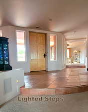 Entryway with ceiling fan and stone tile flooring