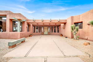 Back of property with stucco siding and a patio area
