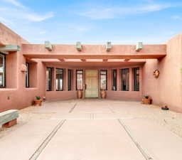 Rear view of house with a patio area and stucco siding
