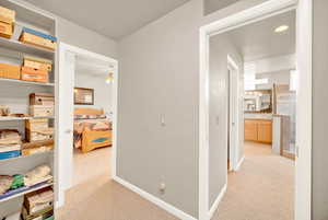 Hall with light colored carpet