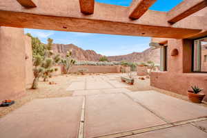 Fenced backyard featuring a patio and a mountain view